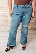 Load image into Gallery viewer, Isla Mid Rise Distressed Released Hem Bootcut Jeans
